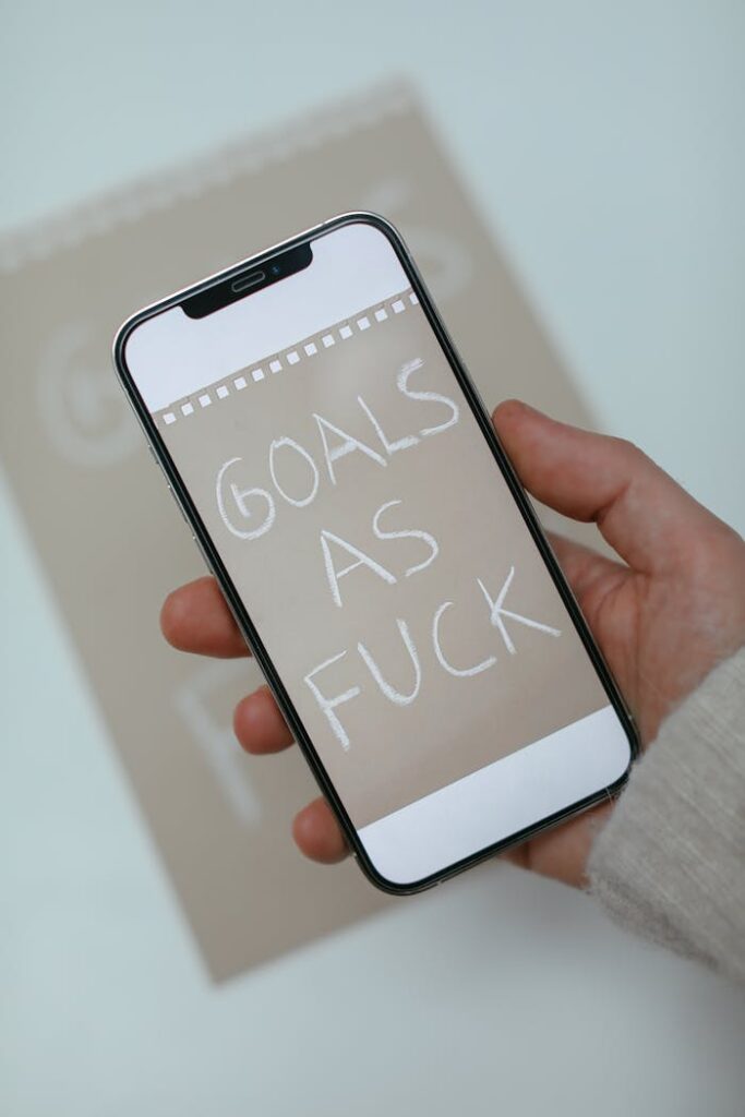 Person Holding Smartphone with Text on Screen Display